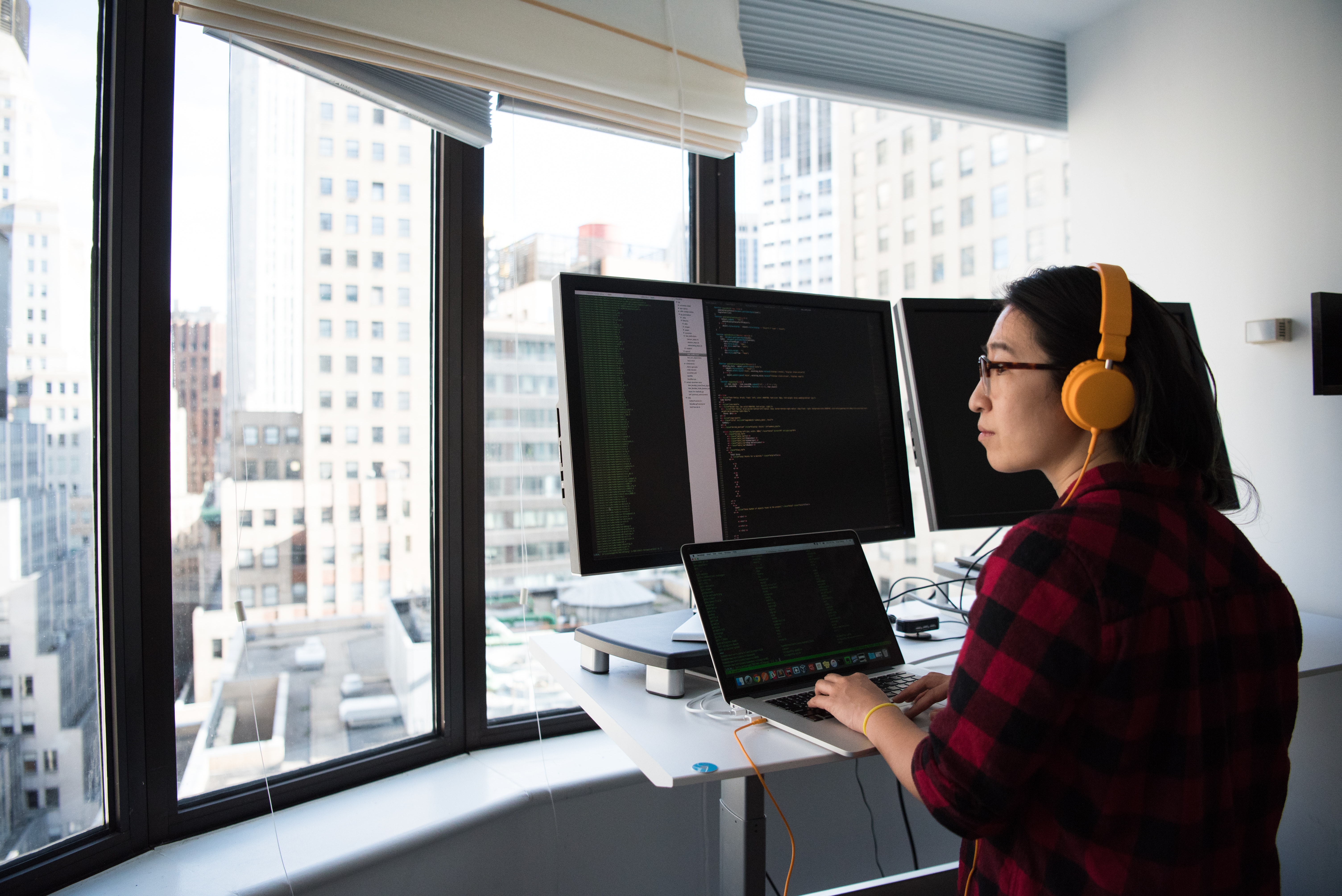 Woman sitting while operating Macbook-pro